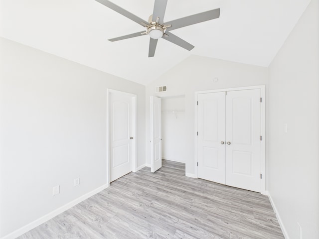 8055 Cambridge St Unit 26, Houston, TX 77054 - unfurnished bedroom featuring light wood-style floors, vaulted ceiling, ceiling fan, and multiple closets