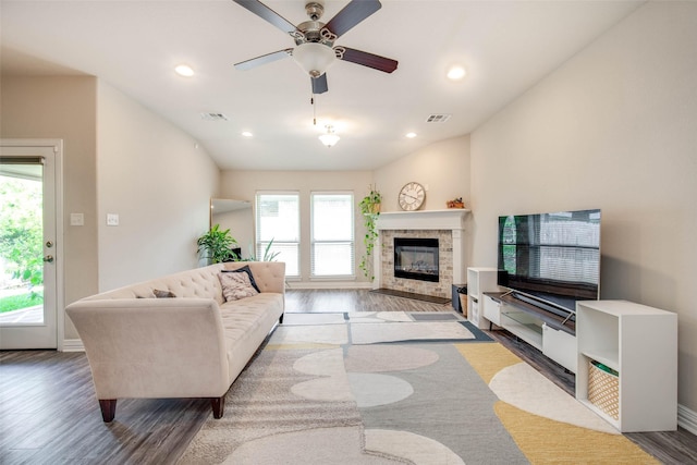 3053 Peterson Cir, Bryan, TX 77802 - living room with wood finished floors, a glass covered fireplace, a ceiling fan, and recessed lighting