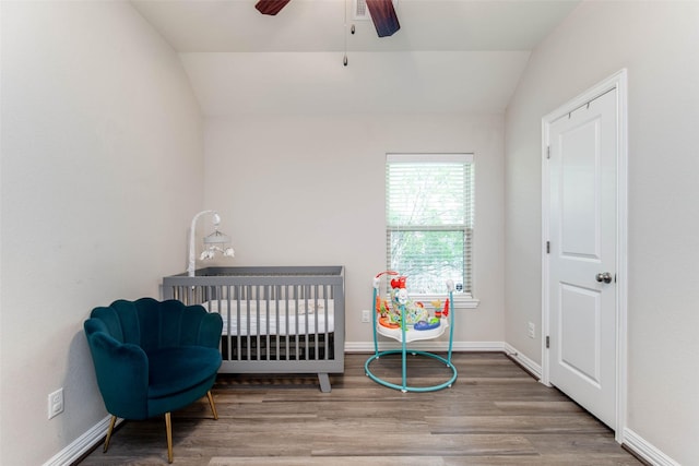 3053 Peterson Cir, Bryan, TX 77802 - bedroom featuring vaulted ceiling, wood finished floors, a nursery area, and a ceiling fan