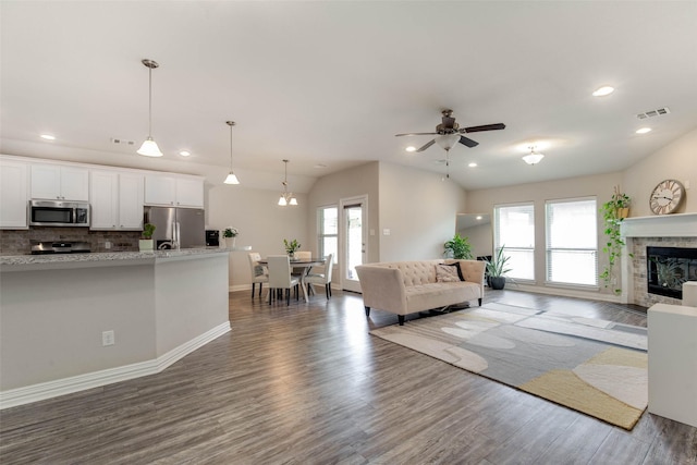3053 Peterson Cir, Bryan, TX 77802 - living room with healthy amount of natural light, wood finished floors, ceiling fan, and recessed lighting