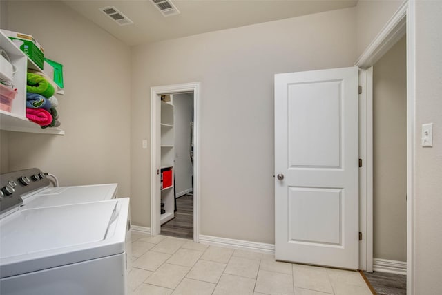 3053 Peterson Cir, Bryan, TX 77802 - laundry area with washing machine and dryer and light tile patterned floors