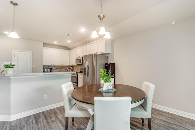 3053 Peterson Cir, Bryan, TX 77802 - dining area with wood finished floors and recessed lighting