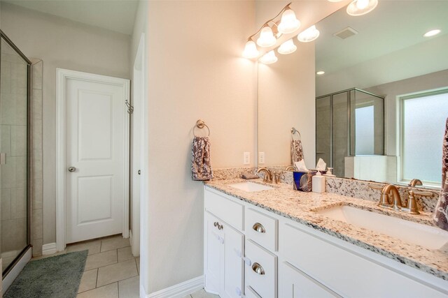 3053 Peterson Cir, Bryan, TX 77802 - bathroom featuring a stall shower, double vanity, tile patterned flooring, and recessed lighting