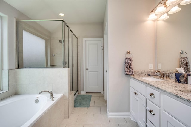 3053 Peterson Cir, Bryan, TX 77802 - full bathroom with vanity, a shower stall, a garden tub, and tile patterned floors