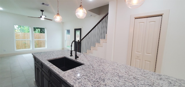 4209 Tampico Rd, Houston, TX 77016 - kitchen featuring open floor plan, dark cabinets, ceiling fan, and pendant lighting