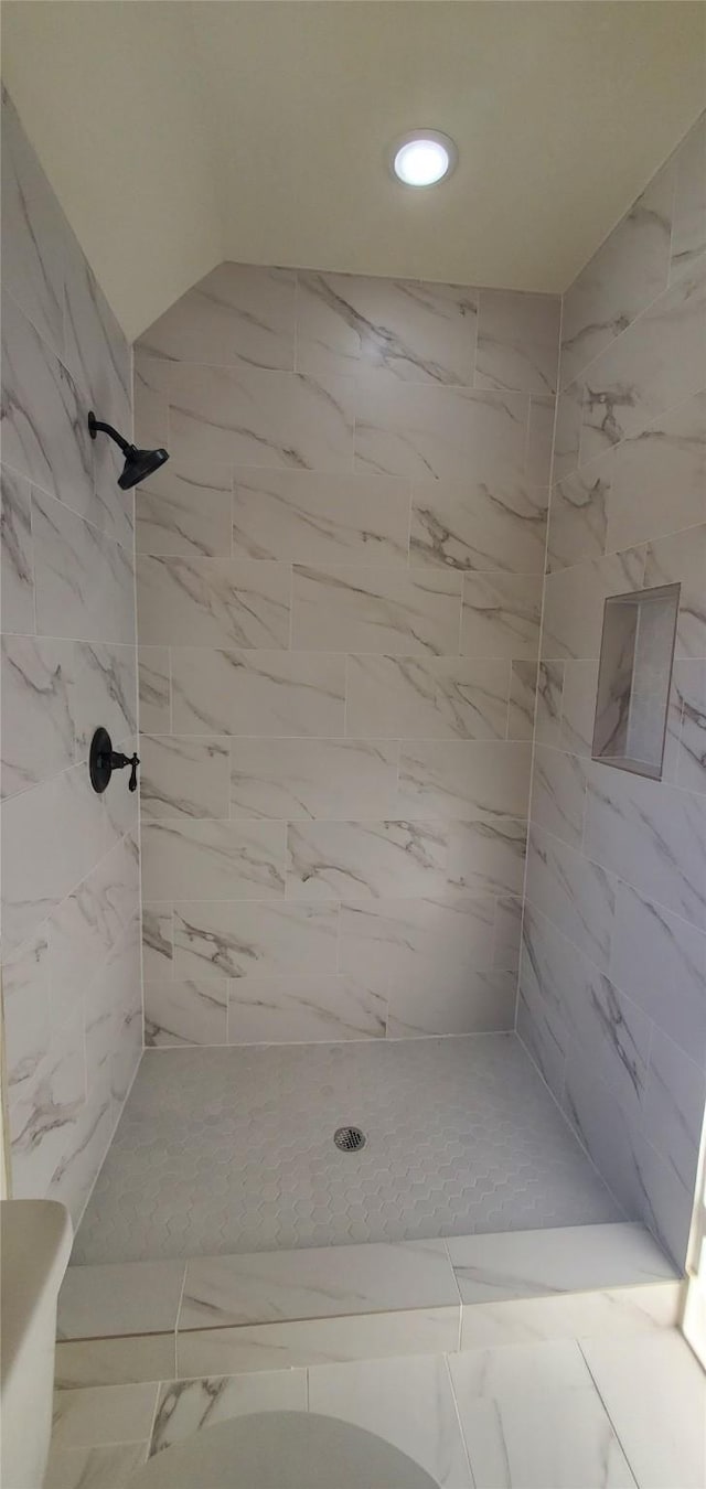4209 Tampico Rd, Houston, TX 77016 - bathroom featuring tiled shower, marble finish floors, and recessed lighting