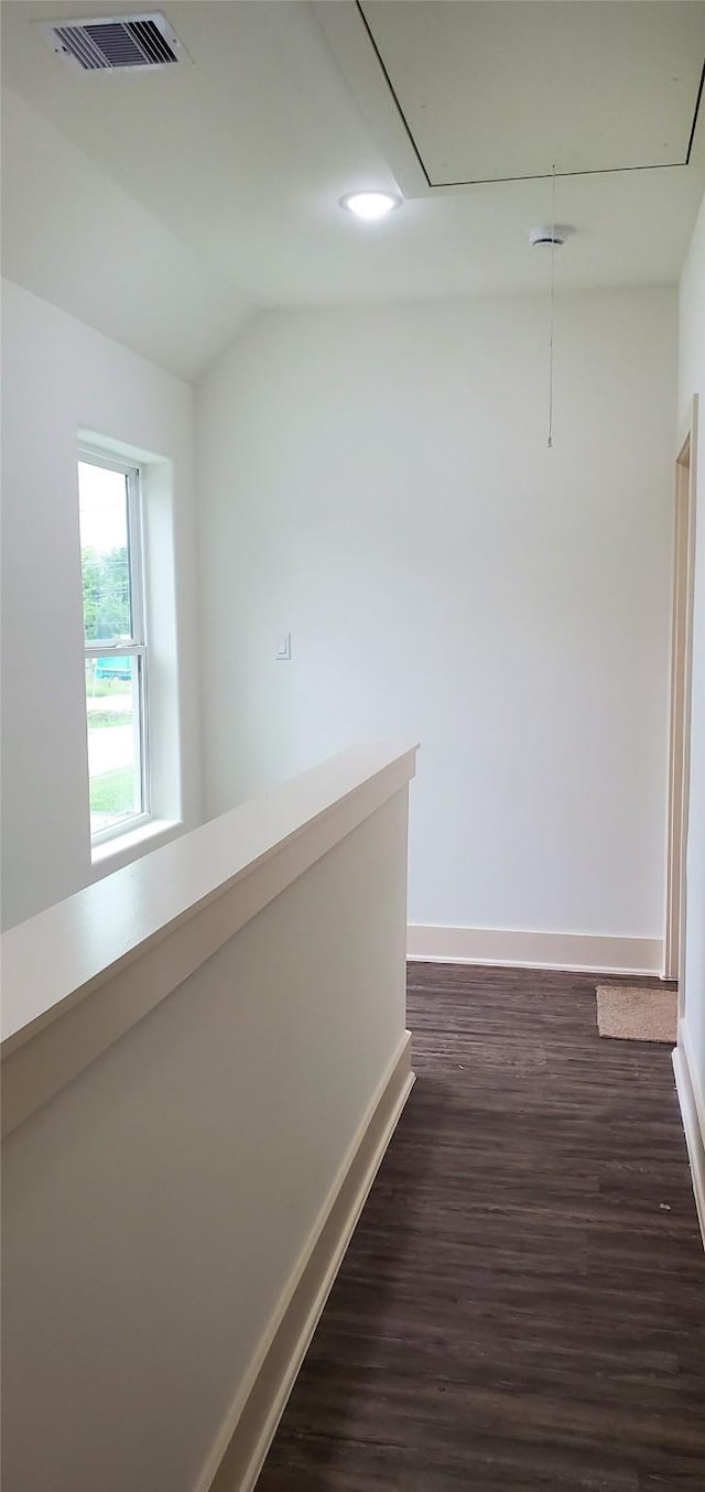 4209 Tampico Rd, Houston, TX 77016 - hallway with attic access, dark wood-type flooring, and vaulted ceiling