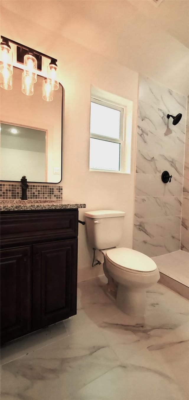 4209 Tampico Rd, Houston, TX 77016 - bathroom featuring a marble finish shower, vanity, marble finish flooring, and decorative backsplash