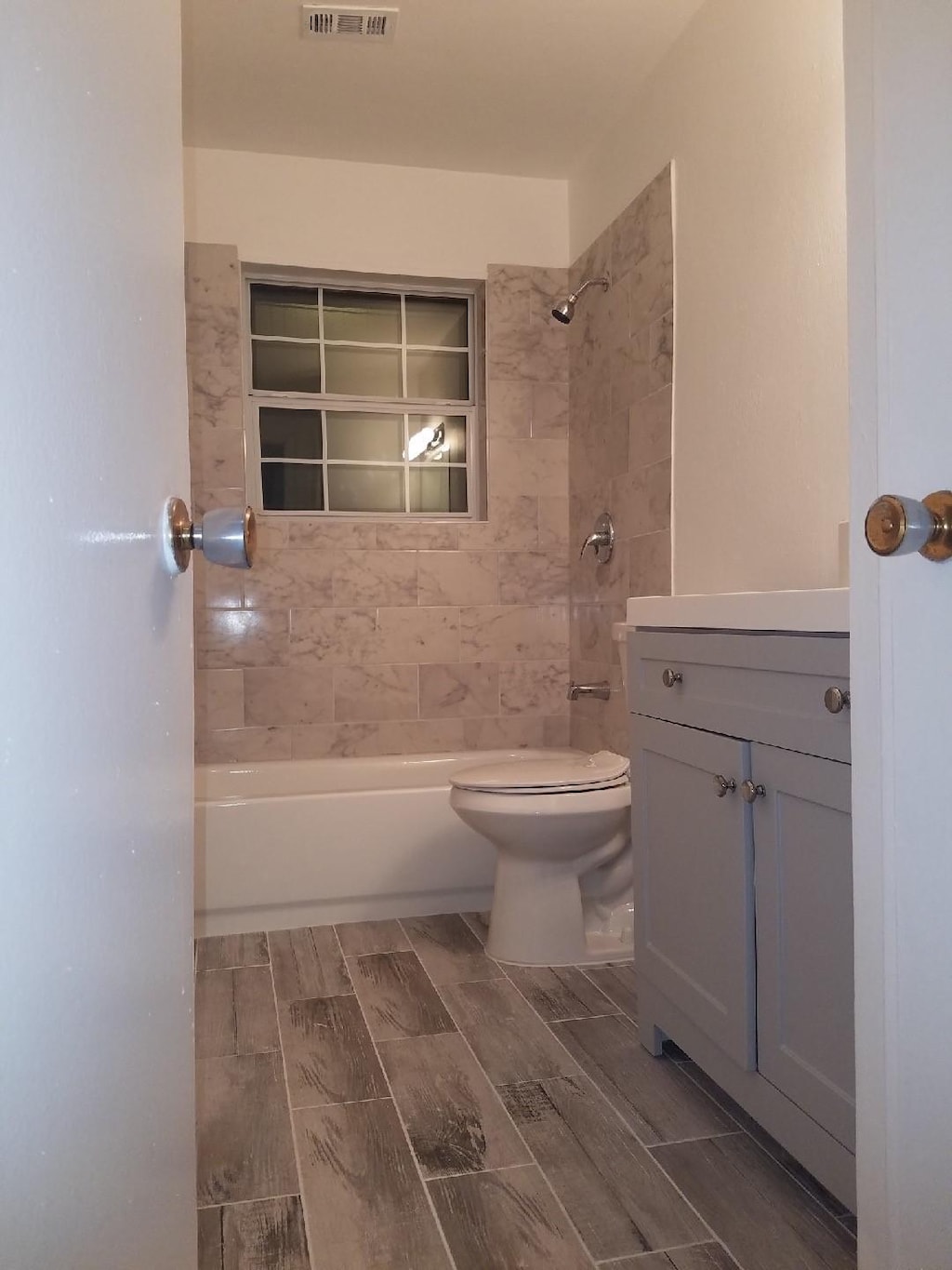 6135 Heatherbrook Dr, Houston, TX 77085 - bathroom with vanity, shower / bath combination, and wood finish floors