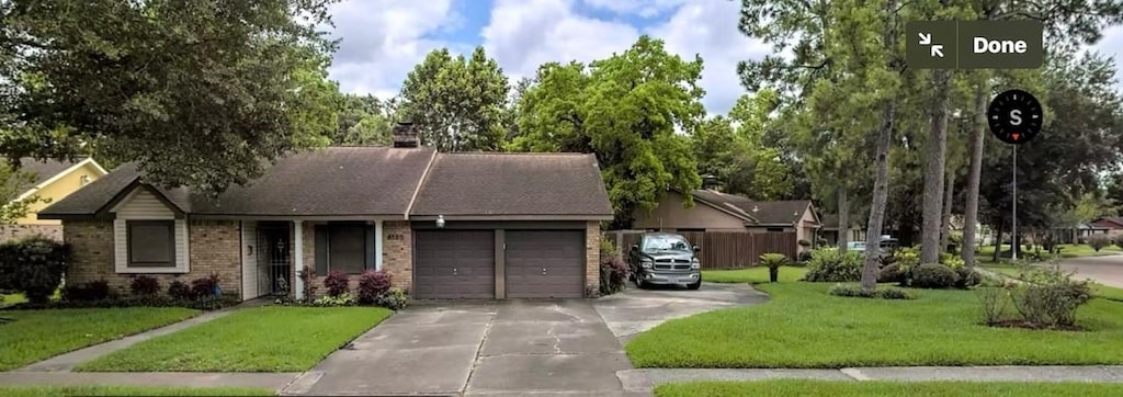 6135 Heatherbrook Dr, Houston, TX 77085 - ranch-style house featuring an attached garage, driveway, brick siding, and a chimney