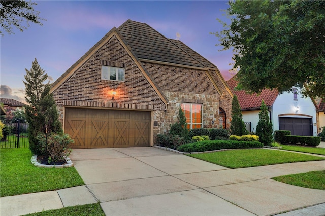 4023 Turning Manor Ln, Sugar Land, TX 77479 - view of front of property featuring driveway, an attached garage, stone siding, and brick siding