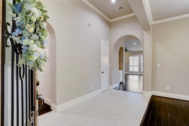 4023 Turning Manor Ln, Sugar Land, TX 77479 - foyer with arched walkways, ornamental molding, light wood-style flooring, and a ceiling fan