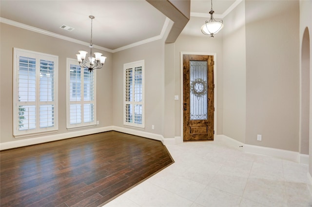 4023 Turning Manor Ln, Sugar Land, TX 77479 - foyer entrance featuring ornamental molding, a chandelier, wood finished floors, and arched walkways
