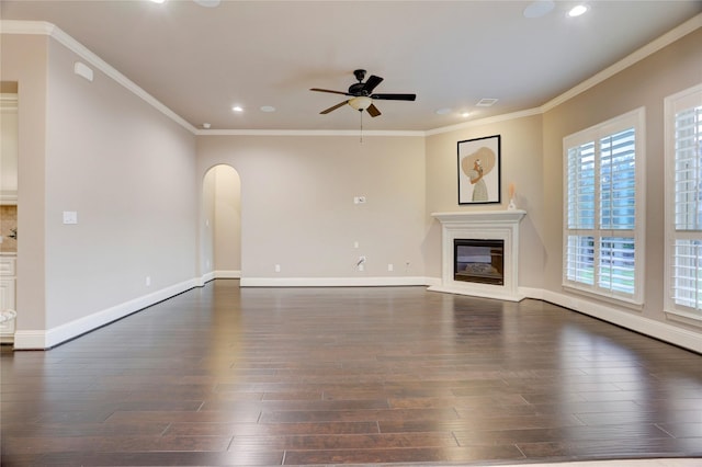 4023 Turning Manor Ln, Sugar Land, TX 77479 - unfurnished living room featuring a ceiling fan, dark wood-style floors, recessed lighting, arched walkways, and ornamental molding