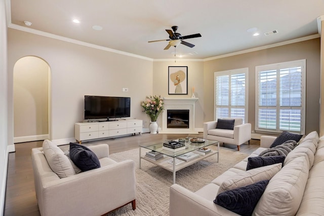 4023 Turning Manor Ln, Sugar Land, TX 77479 - living area featuring ceiling fan, wood finished floors, ornamental molding, a glass covered fireplace, and recessed lighting