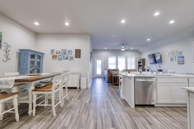 10026 Angelina Woods Ln, Conroe, TX 77384 - kitchen with stainless steel dishwasher, open floor plan, white cabinets, ceiling fan, and light countertops