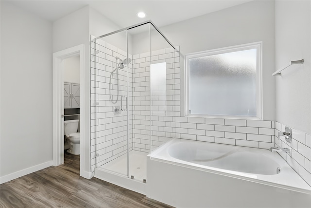 10026 Angelina Woods Ln, Conroe, TX 77384 - bathroom with a garden tub, a stall shower, and wood finished floors