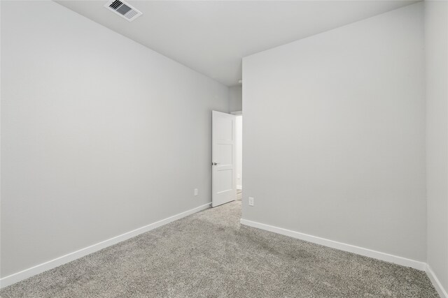 10026 Angelina Woods Ln, Conroe, TX 77384 - spare room featuring light carpet and baseboards