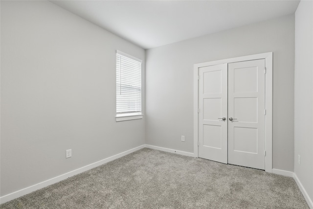 10026 Angelina Woods Ln, Conroe, TX 77384 - unfurnished bedroom featuring carpet floors and a closet