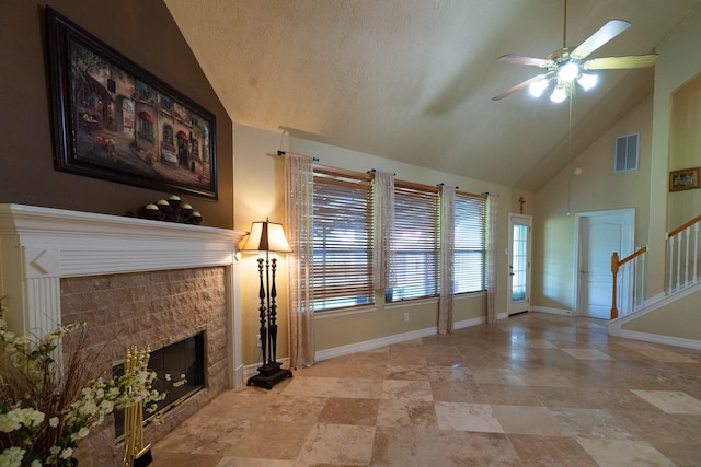 22110 Nobles Crossing Dr, Spring, TX 77373 - unfurnished living room with a ceiling fan, a tile fireplace, stairs, and high vaulted ceiling