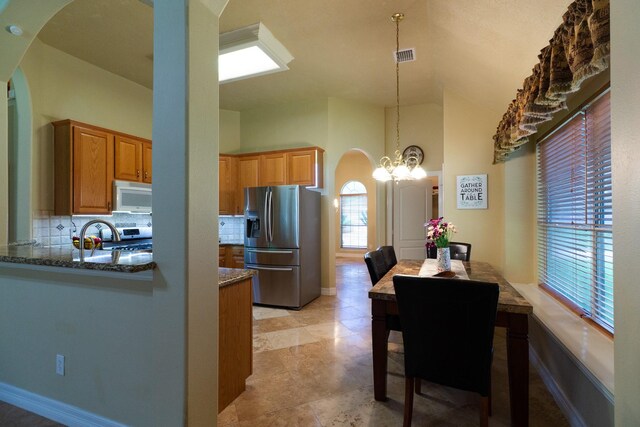 22110 Nobles Crossing Dr, Spring, TX 77373 - dining space featuring arched walkways, a chandelier, and high vaulted ceiling