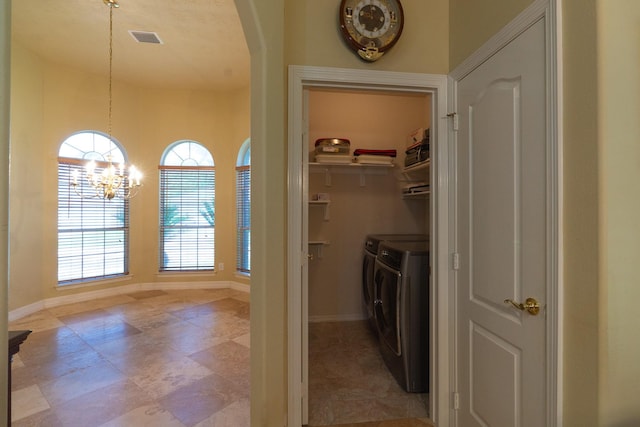 22110 Nobles Crossing Dr, Spring, TX 77373 - laundry area with independent washer and dryer, a chandelier, and arched walkways