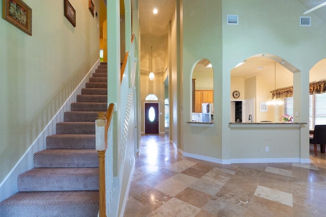 22110 Nobles Crossing Dr, Spring, TX 77373 - stairway with a towering ceiling and arched walkways