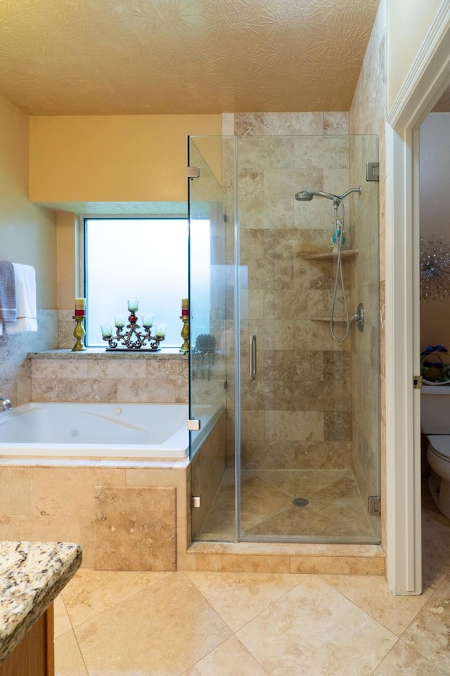 22110 Nobles Crossing Dr, Spring, TX 77373 - bathroom featuring a bath, a stall shower, and tile patterned floors