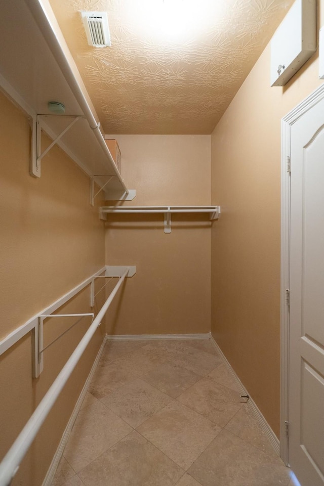 22110 Nobles Crossing Dr, Spring, TX 77373 - walk in closet featuring light tile patterned floors