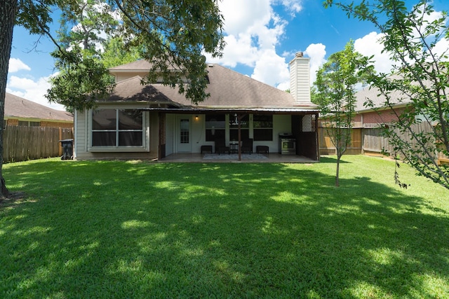 22110 Nobles Crossing Dr, Spring, TX 77373 - back of house featuring a fenced backyard, a chimney, a patio, and a shingled roof
