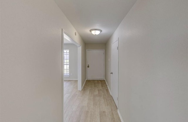 12938 S Coast Dr, Houston, TX 77047 - hall featuring light wood finished floors and baseboards