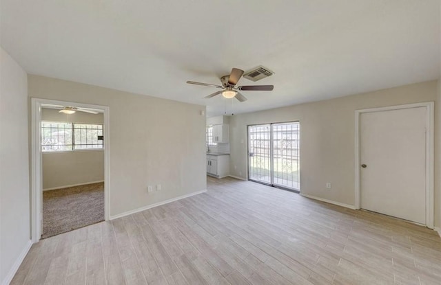 12938 S Coast Dr, Houston, TX 77047 - empty room with ceiling fan, plenty of natural light, and light wood-style flooring
