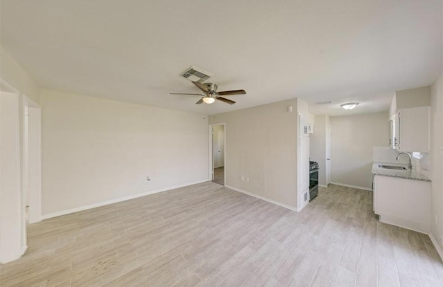12938 S Coast Dr, Houston, TX 77047 - unfurnished living room with light wood-style floors and a ceiling fan