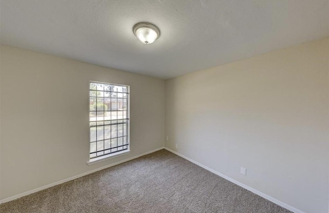 12938 S Coast Dr, Houston, TX 77047 - carpeted empty room featuring baseboards and a textured ceiling