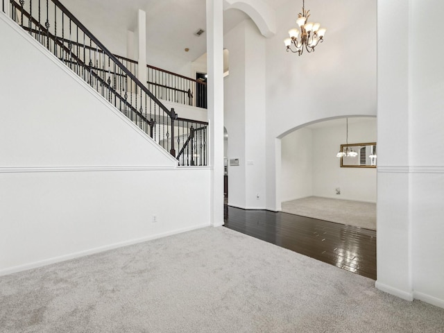 421 White Oak Pointe, League City, TX 77573 - entrance foyer with a chandelier, carpet flooring, arched walkways, a towering ceiling, and stairs