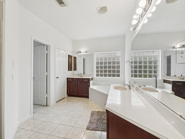 421 White Oak Pointe, League City, TX 77573 - full bathroom featuring a bath, two vanities, and tile patterned floors