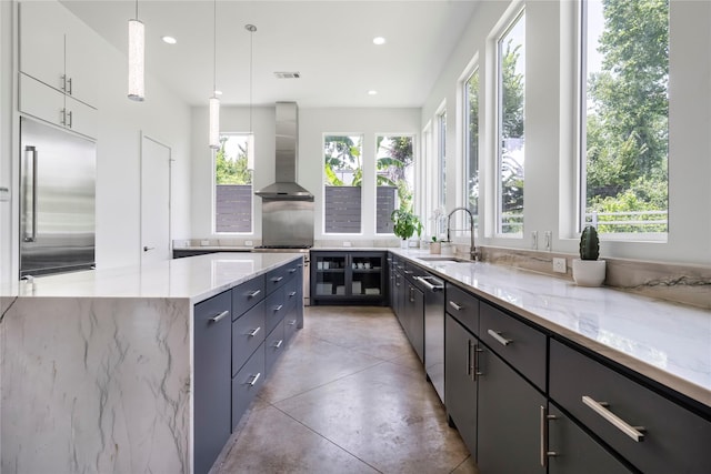 543 Threlkeld St, Houston, TX 77007 - kitchen with ventilation hood, appliances with stainless steel finishes, plenty of natural light, light stone countertops, and recessed lighting