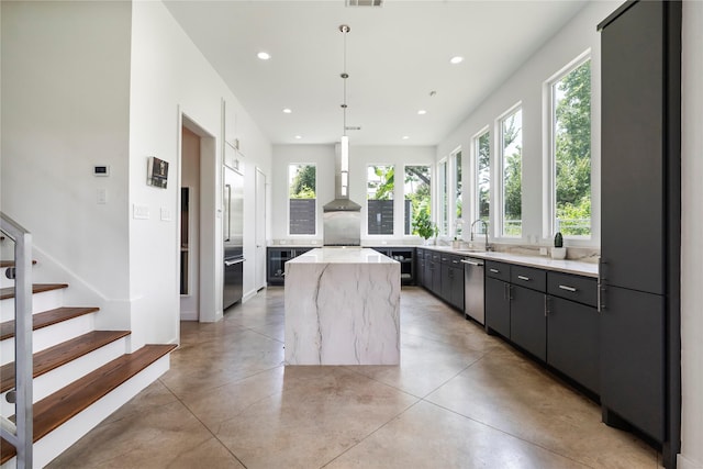 543 Threlkeld St, Houston, TX 77007 - kitchen featuring appliances with stainless steel finishes, a center island, concrete flooring, recessed lighting, and wall chimney exhaust hood