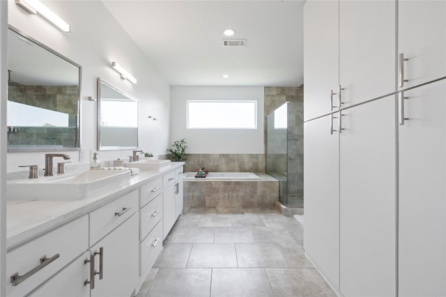 543 Threlkeld St, Houston, TX 77007 - bathroom with a shower stall, a garden tub, double vanity, tile patterned floors, and recessed lighting