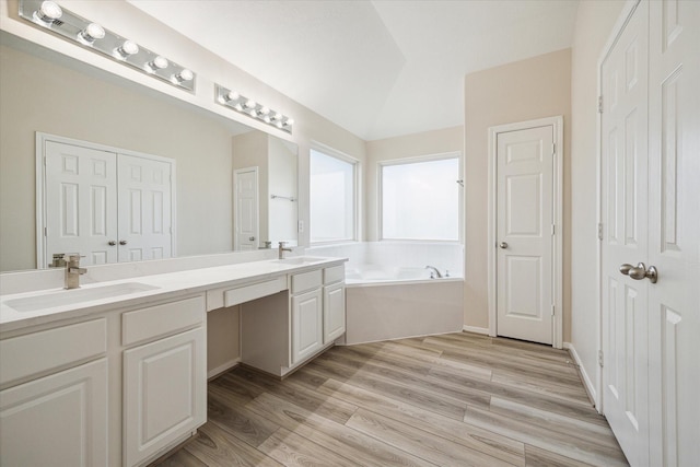 2439 Chuckberry St, Houston, TX 77080 - bathroom featuring double vanity, a bath, and wood finished floors