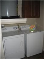 1711 Old Spanish Trl Unit 343, Houston, TX 77054 - washroom with washing machine and clothes dryer and cabinet space