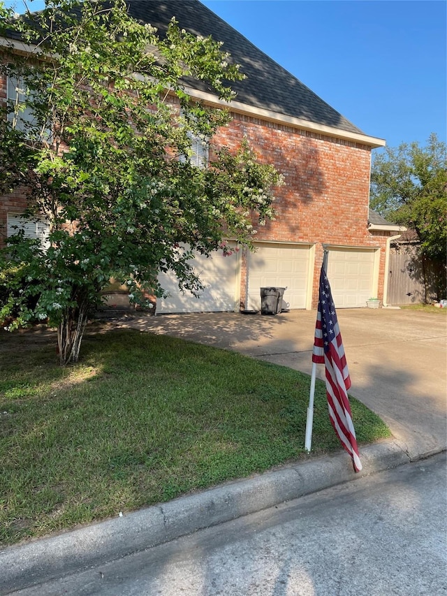 4202 Astwood Ct, Houston, TX 77068 - view of home's exterior featuring brick siding, an attached garage, concrete driveway, roof with shingles, and a yard