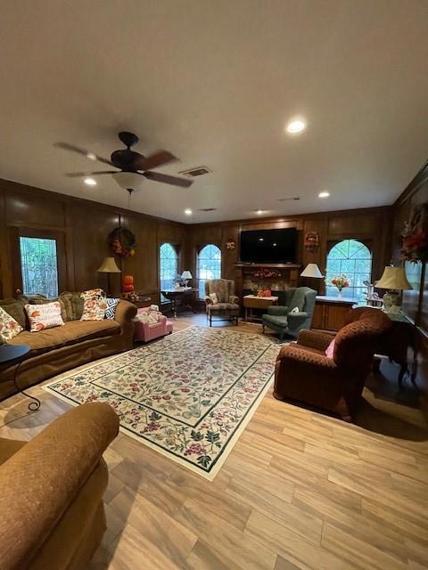 4202 Astwood Ct, Houston, TX 77068 - living room with ceiling fan, wooden walls, wood finished floors, and recessed lighting