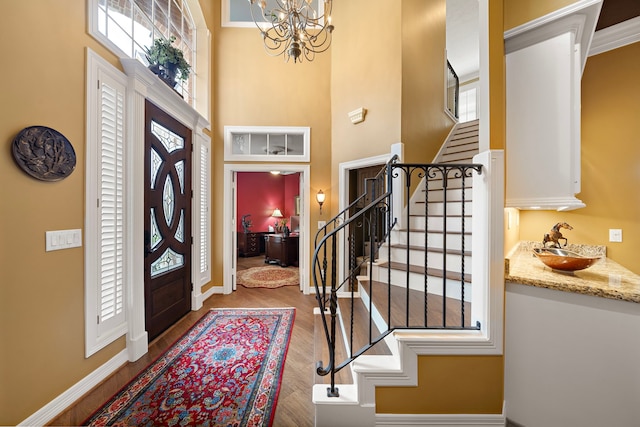 1310 Whispering Pines Dr, Houston, TX 77055 - entrance foyer featuring stairs, a high ceiling, a chandelier, plenty of natural light, and wood finished floors