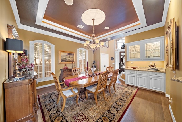 1310 Whispering Pines Dr, Houston, TX 77055 - dining space with a tray ceiling, hardwood / wood-style floors, a chandelier, and ornamental molding