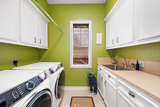 1310 Whispering Pines Dr, Houston, TX 77055 - laundry area featuring washer and dryer, cabinet space, and light tile patterned floors
