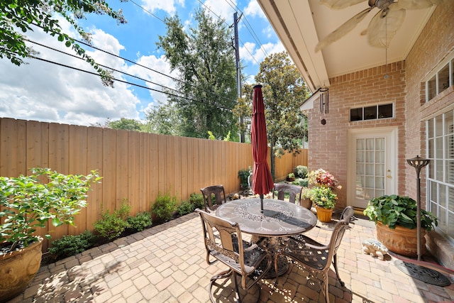 1310 Whispering Pines Dr, Houston, TX 77055 - fenced backyard with a patio area, outdoor dining space, and ceiling fan