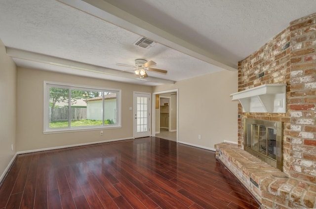 15622 Sunset Rock Dr, Houston, TX 77084 - unfurnished living room with a textured ceiling, a brick fireplace, wood finished floors, and ceiling fan