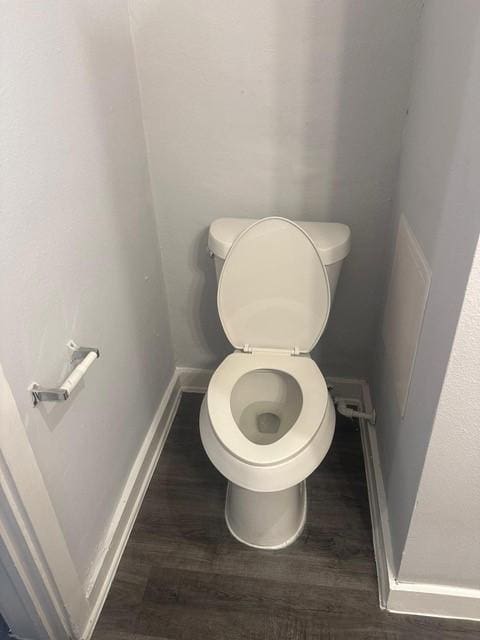 1120 W Robinson St, Alvin, TX 77511 - bathroom with toilet and wood finished floors