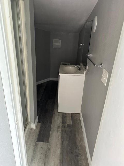 1120 W Robinson St, Alvin, TX 77511 - bathroom featuring wood finished floors, vanity, and a shower with shower door